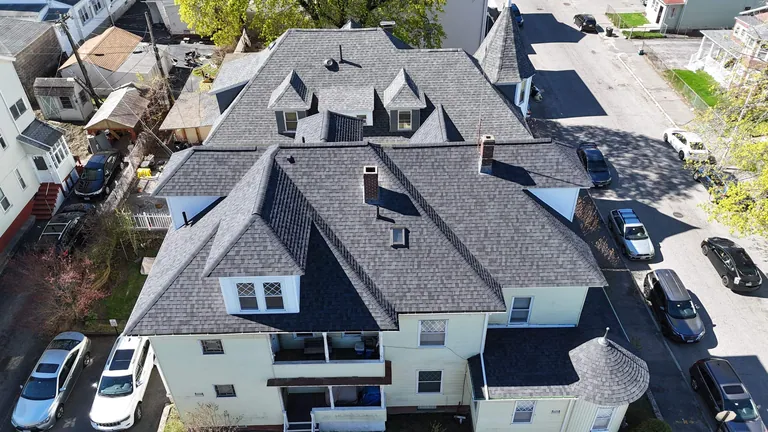 Aerial urban multifamily gray roof