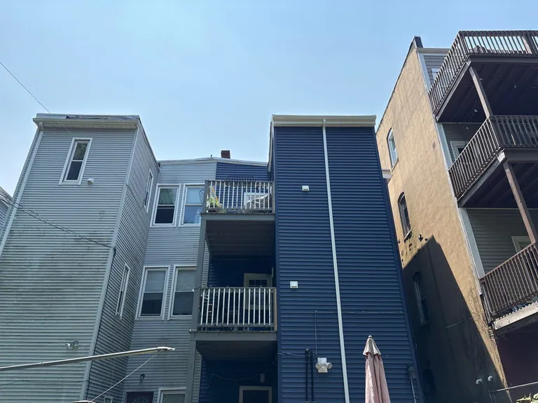 Blue siding triple decker boston