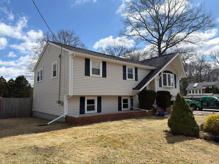 Cream split level new vinyl siding