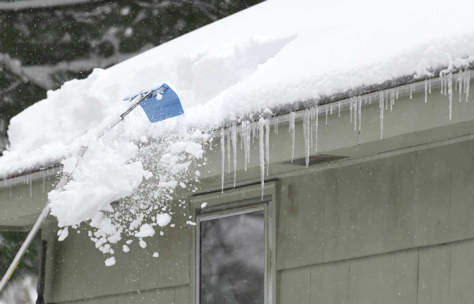 Removing snow on the roof after snow storm